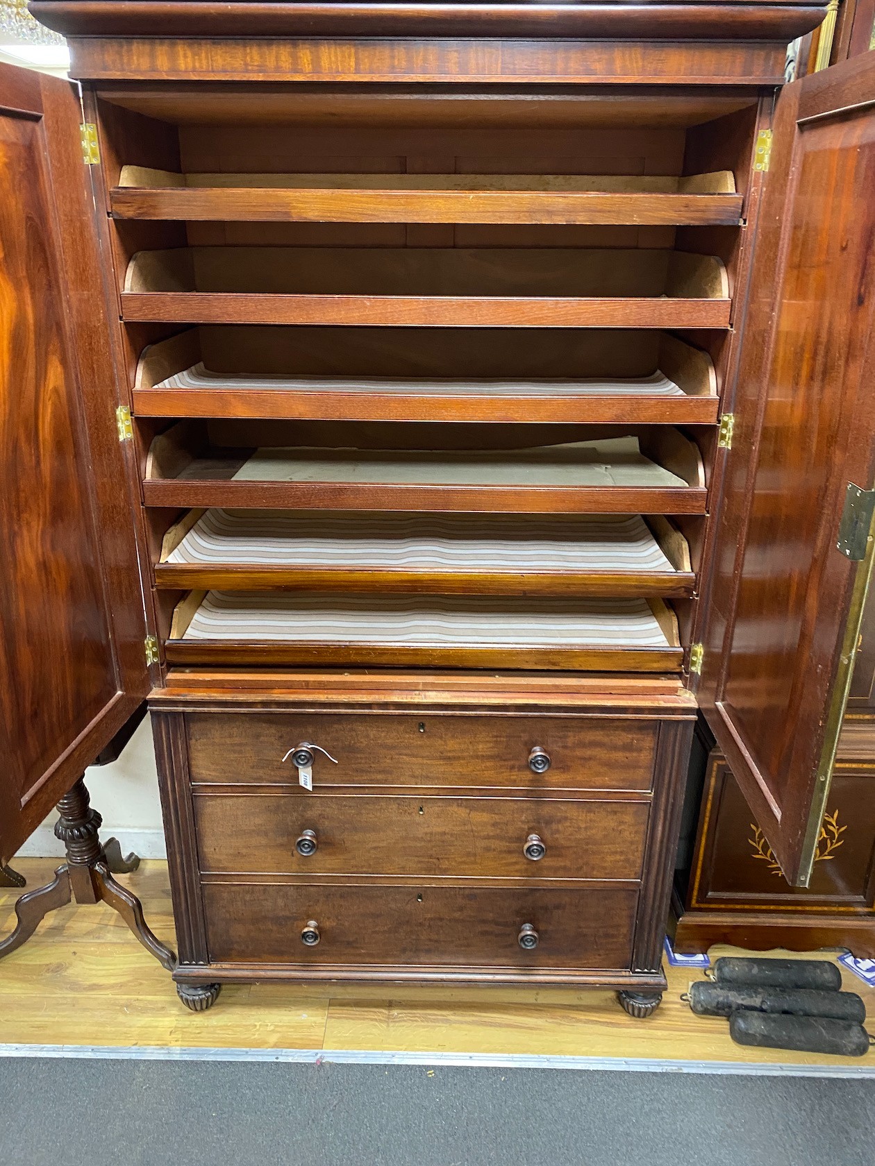 A George IV mahogany linen press of small proportions with three long drawers, width 115cm, depth 55cm, height 198cm